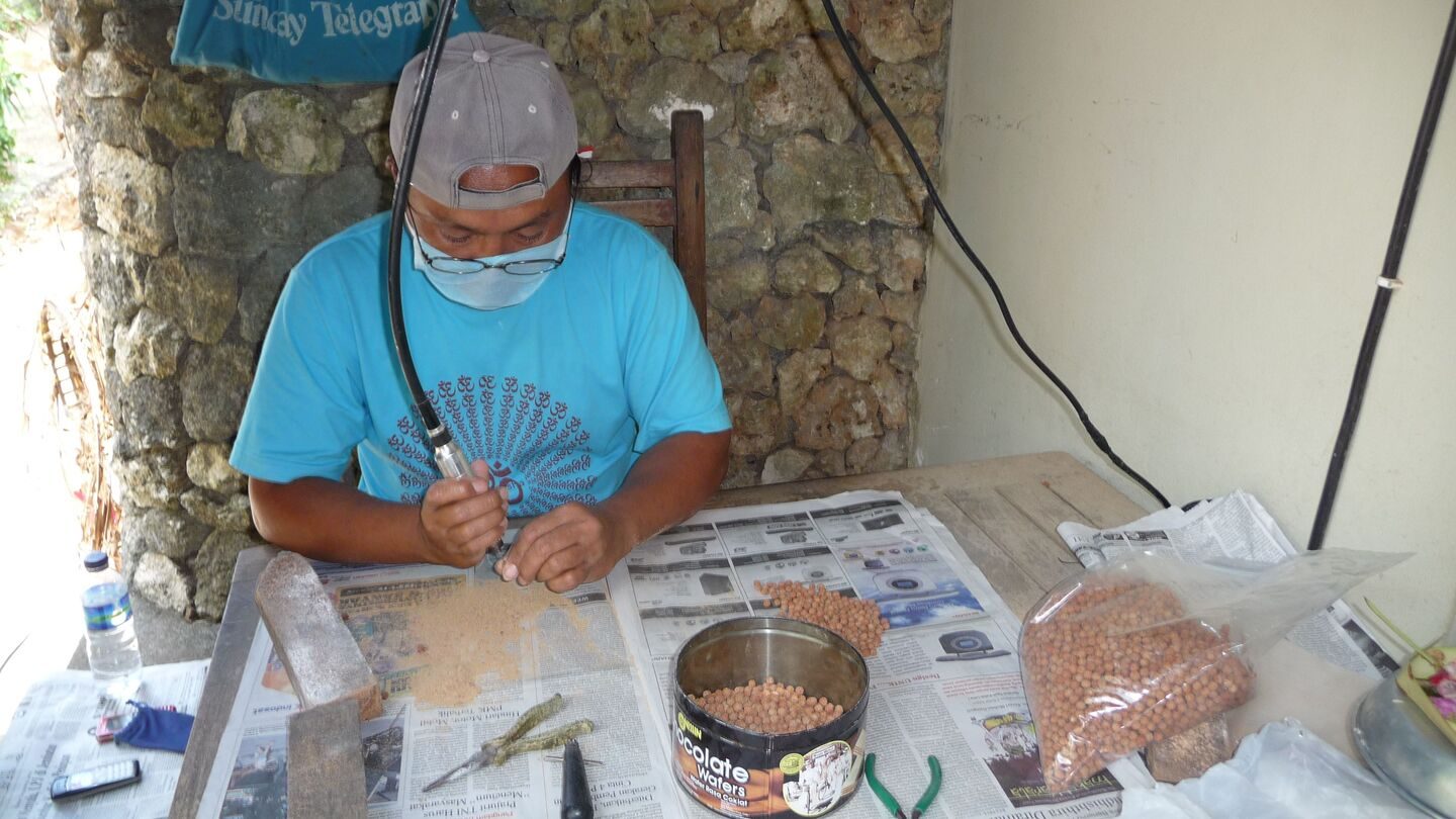 Rudraksha Mala Beads: Origin, Meaning and How to Use Them 14 A craftsman drilling a rudraksha bead by hand in the workshop in Bali